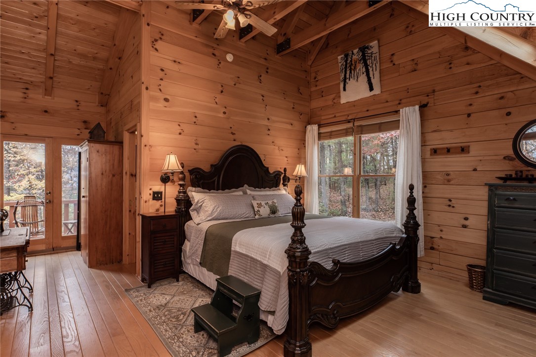 899 Bobcat Mountain Road Purlear, NC 28665 - Photo 29 of 50 a bedroom with a bed and wooden floor