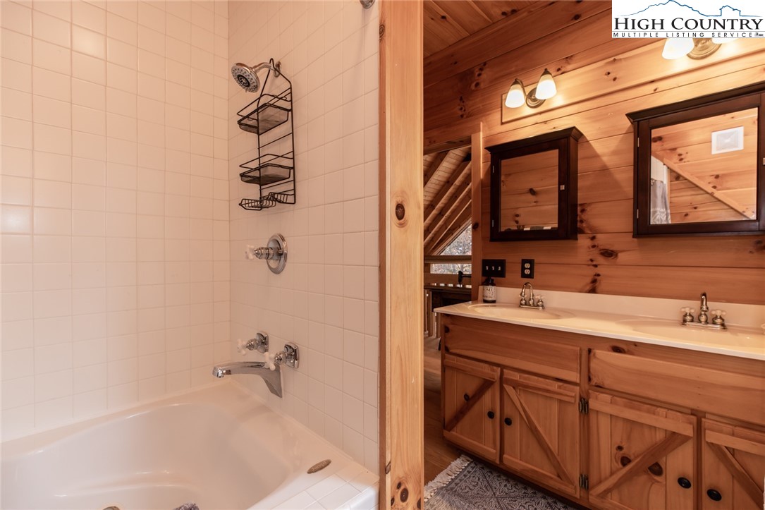 899 Bobcat Mountain Road Purlear, NC 28665 - Photo 32 of 50 a bathroom with a sink and a mirror