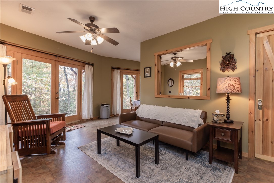 899 Bobcat Mountain Road Purlear, NC 28665 - Photo 41 of 50 a living room with furniture and a chandelier
