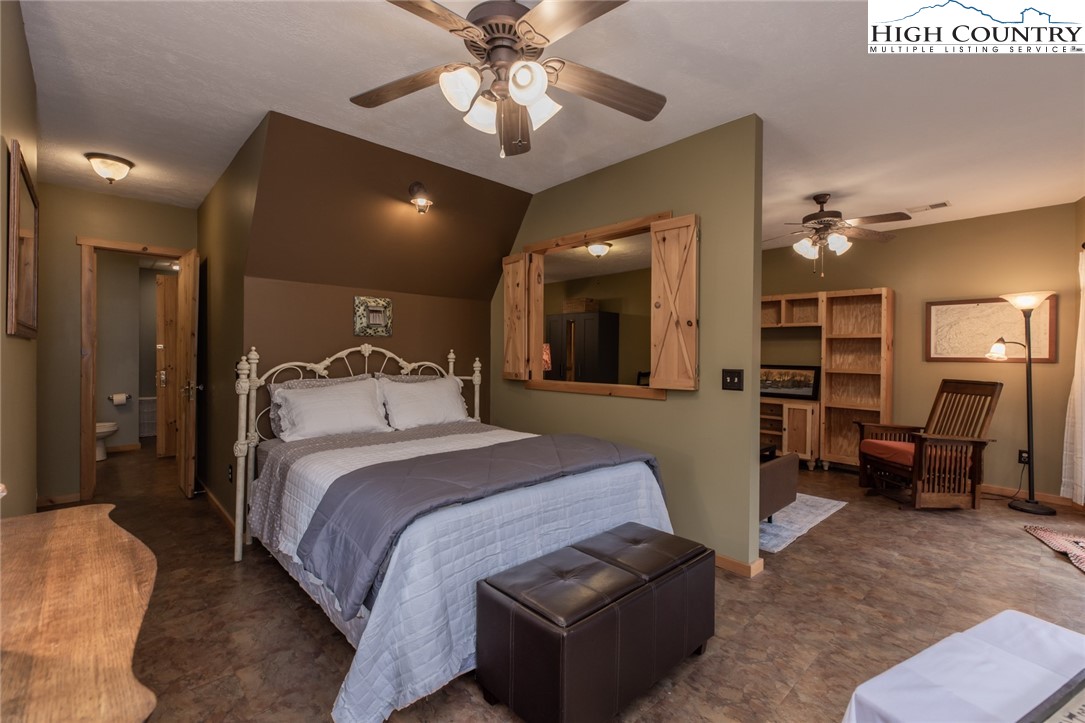 899 Bobcat Mountain Road Purlear, NC 28665 - Photo 43 of 50 a bed room with a bed and furniture