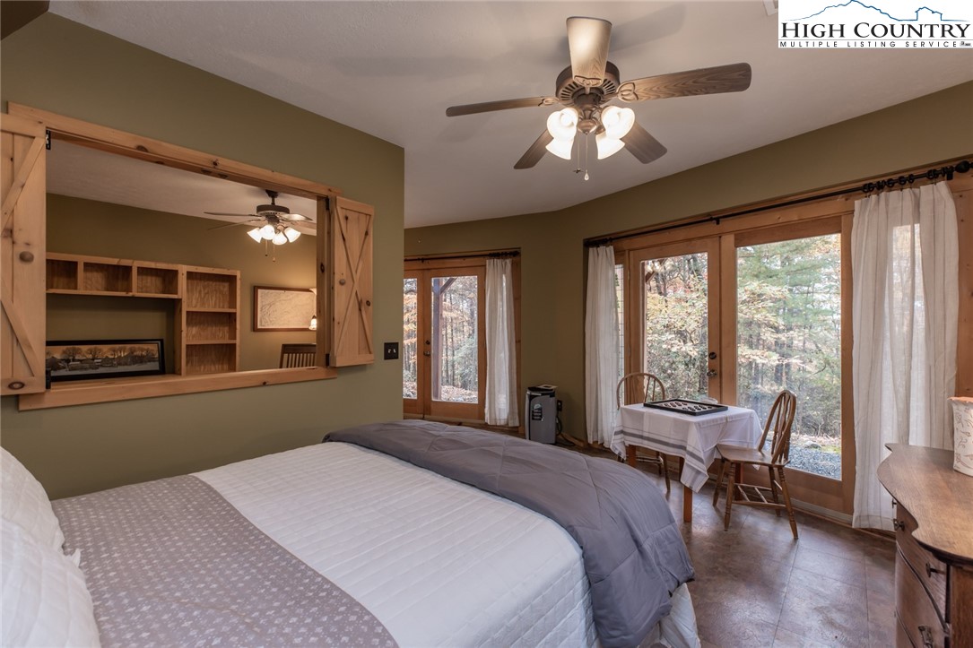 899 Bobcat Mountain Road Purlear, NC 28665 - Photo 44 of 50 a bedroom with a large bed and a large window