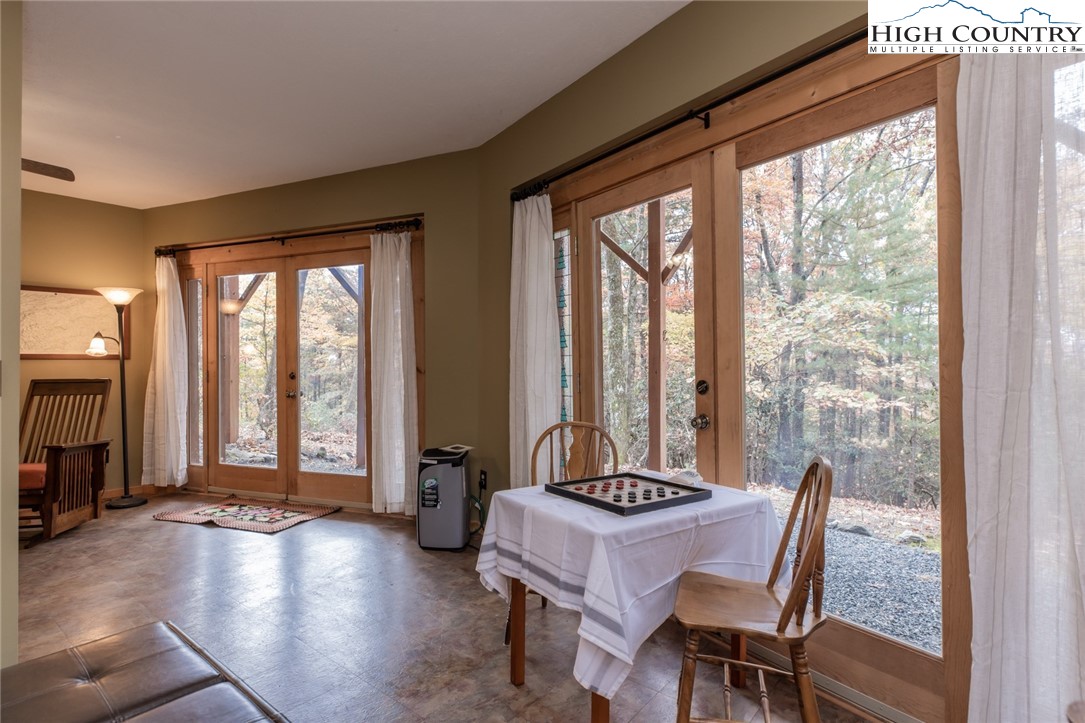 899 Bobcat Mountain Road Purlear, NC 28665 - Photo 45 of 50 a living room with furniture and floor to ceiling windows