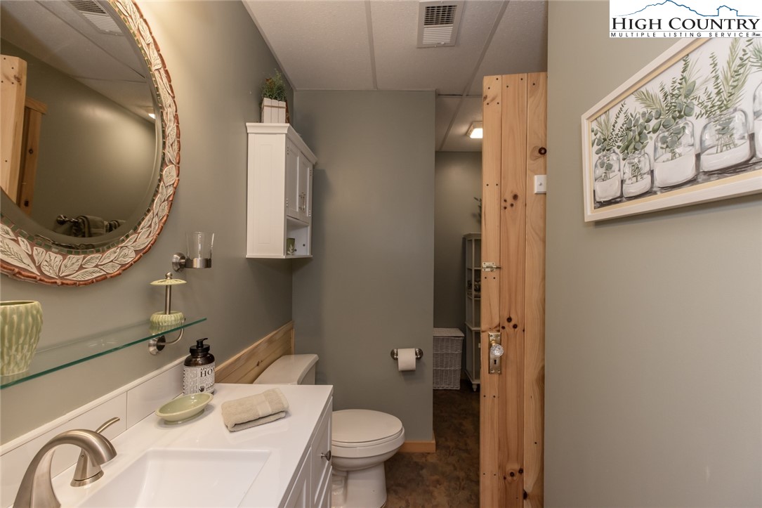 899 Bobcat Mountain Road Purlear, NC 28665 - Photo 46 of 50 a bathroom with a sink and a mirror