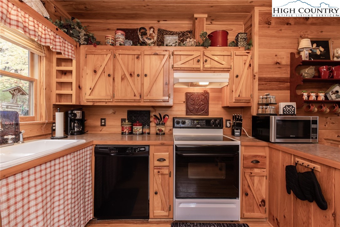 899 Bobcat Mountain Road Purlear, NC 28665 - Photo 5 of 50 a kitchen with stainless steel appliances granite countertop a stove and a sink