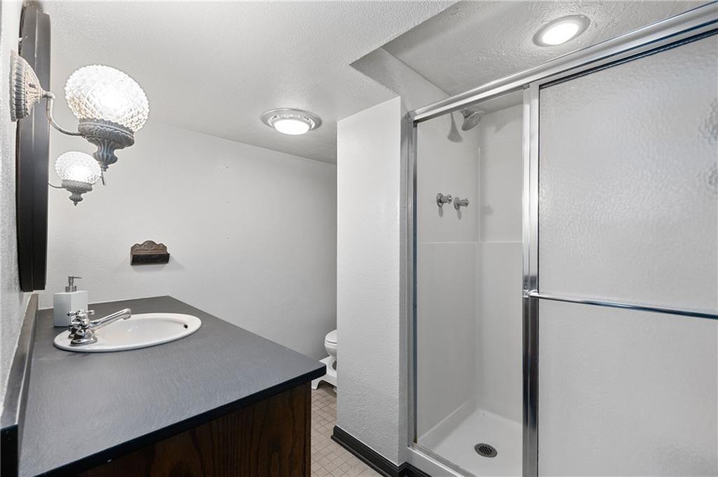 720 Wible Run Road Pittsburgh, PA 15209 - Photo 13 of 24 a bathroom with a sink a mirror and shower