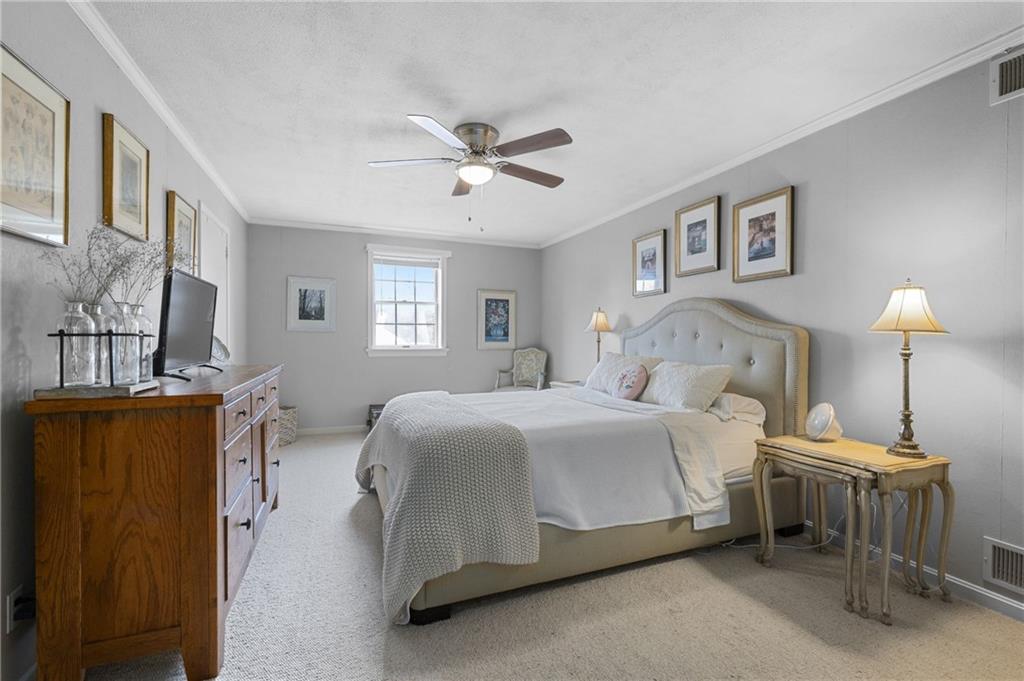 720 Wible Run Road Pittsburgh, PA 15209 - Photo 16 of 24 a spacious bedroom with a bed chandelier and a window