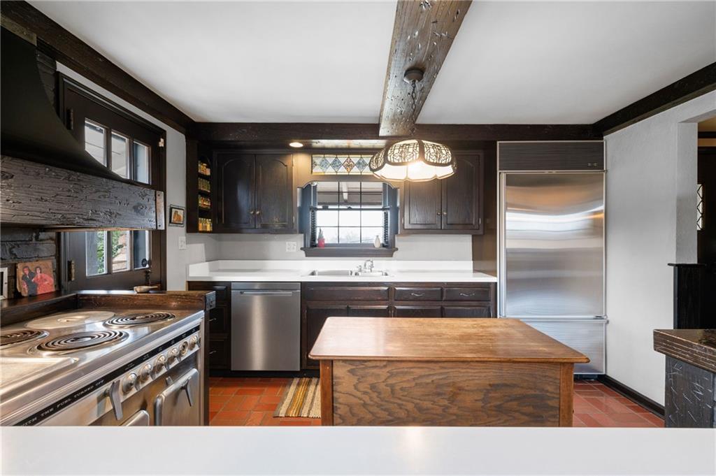 720 Wible Run Road Pittsburgh, PA 15209 - Photo 6 of 24 a kitchen with a stove a sink and a refrigerator
