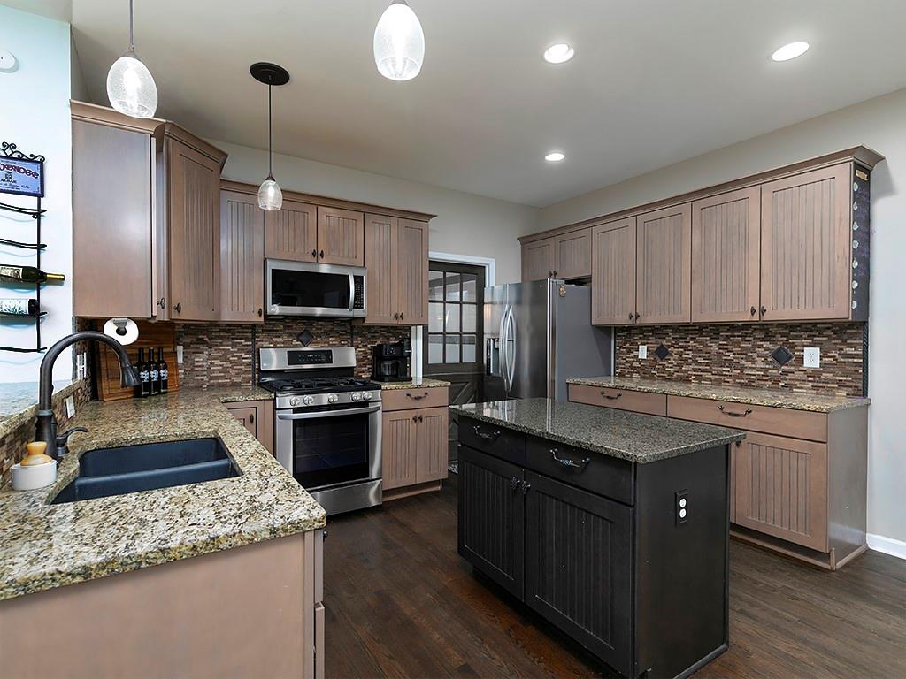 117 Constitution Pointe Dallas, GA 30132 - Photo 12 of 50 a kitchen with stainless steel appliances granite countertop a sink stove and refrigerator