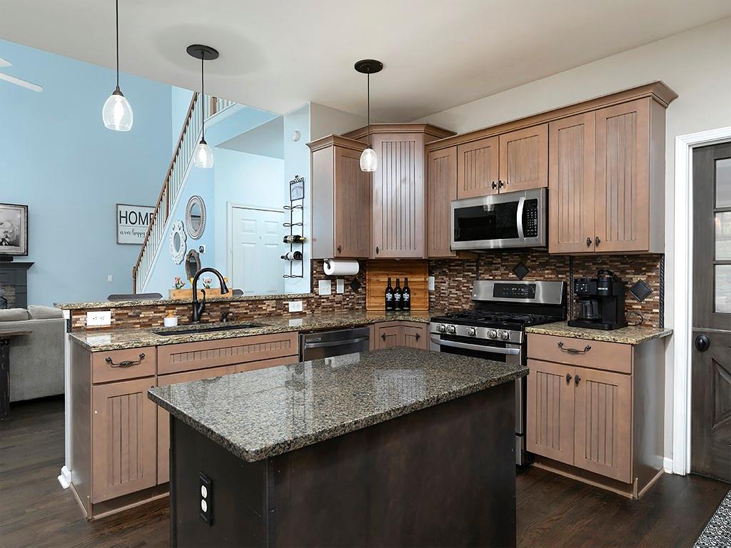 117 Constitution Pointe Dallas, GA 30132 - Photo 14 of 50 a kitchen with stainless steel appliances granite countertop a sink stove and refrigerator