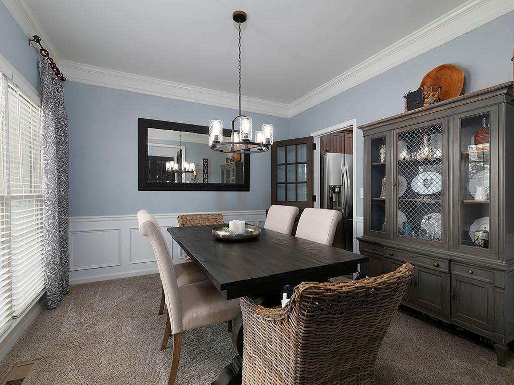 117 Constitution Pointe Dallas, GA 30132 - Photo 17 of 50 a view of a dining room with furniture and chandelier