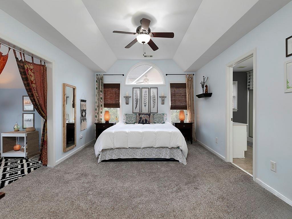 117 Constitution Pointe Dallas, GA 30132 - Photo 23 of 50 a spacious bedroom with a large bed and a chandelier
