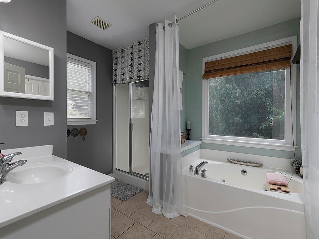 117 Constitution Pointe Dallas, GA 30132 - Photo 25 of 50 a bathroom with a tub sink and mirror