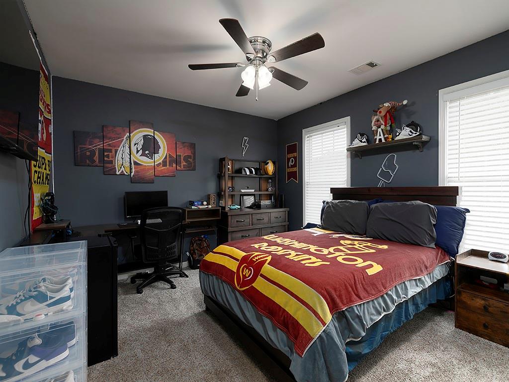 117 Constitution Pointe Dallas, GA 30132 - Photo 33 of 50 a bedroom with a bed and a flat screen tv