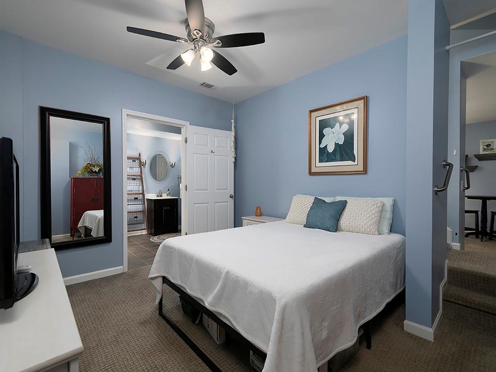 117 Constitution Pointe Dallas, GA 30132 - Photo 34 of 50 a spacious bedroom with a bed and a chandelier