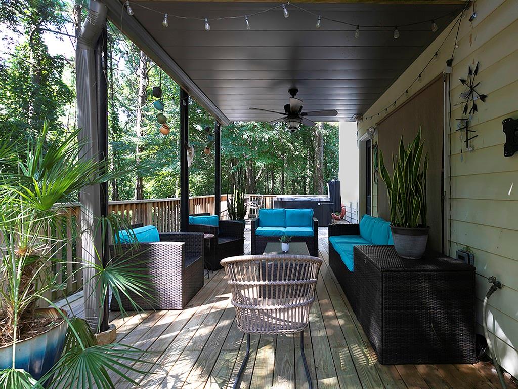 117 Constitution Pointe Dallas, GA 30132 - Photo 39 of 50 a view of a patio with couches chairs dining table and chairs with wooden floor