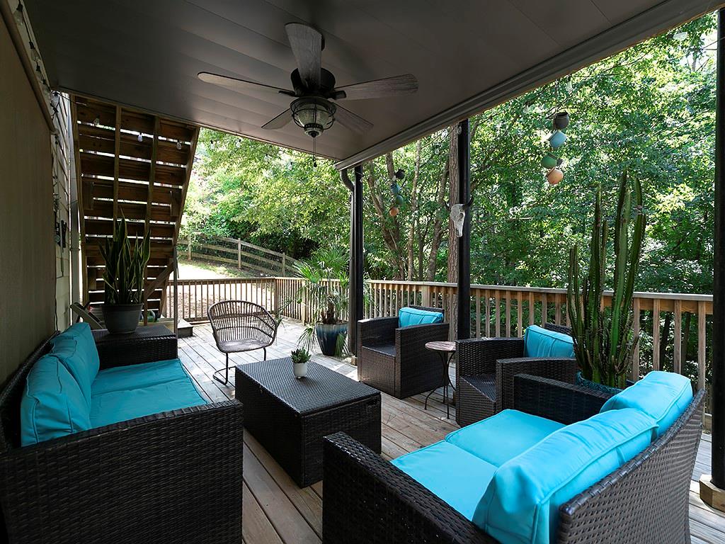117 Constitution Pointe Dallas, GA 30132 - Photo 40 of 50 a view of a patio with couches chairs potted plants and wooden floor