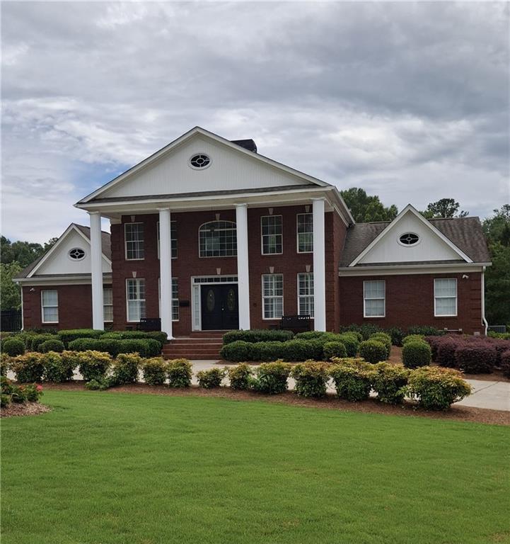 117 Constitution Pointe Dallas, GA 30132 - Photo 43 of 50 a front view of a house with a garden