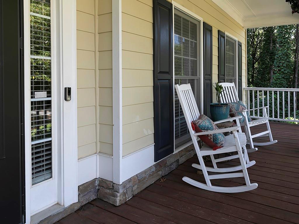 117 Constitution Pointe Dallas, GA 30132 - Photo 5 of 50 a view of a balcony with wooden floor and chairs