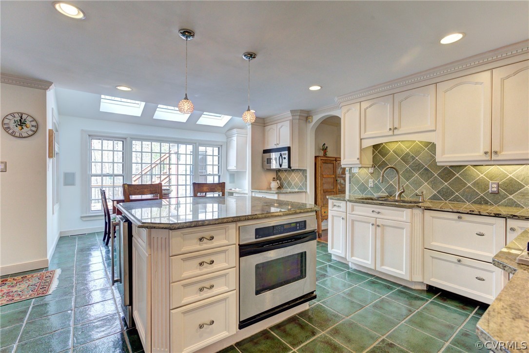 9810 Kingsbridge Road Henrico, VA 23238 - Photo 14 of 32 a kitchen with granite countertop white cabinets and white appliances