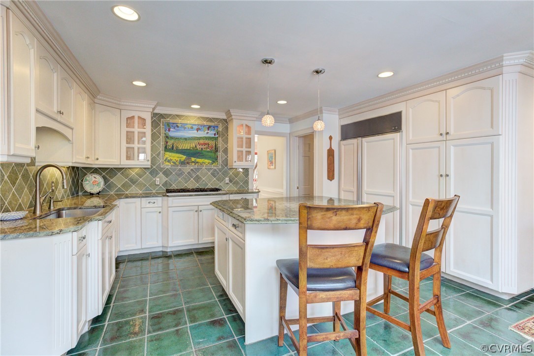9810 Kingsbridge Road Henrico, VA 23238 - Photo 15 of 32 a kitchen with kitchen island granite countertop wooden cabinets and white appliances