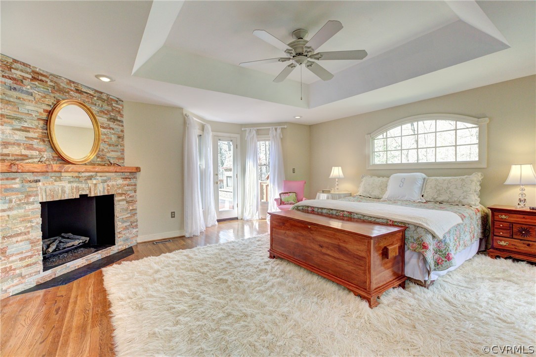 9810 Kingsbridge Road Henrico, VA 23238 - Photo 19 of 32 a spacious bedroom with a bed a fireplace and windows