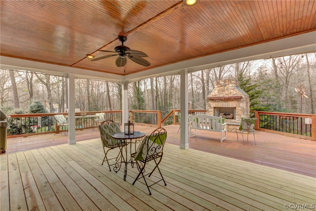 9810 Kingsbridge Road Henrico, VA 23238 - Photo 31 of 32 a dining room with wooden floor glass walls table and chairs
