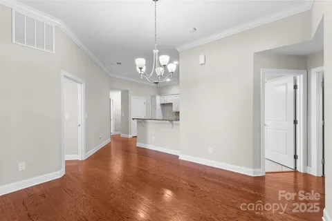 a view of a kitchen with wooden floor and a ceiling fan