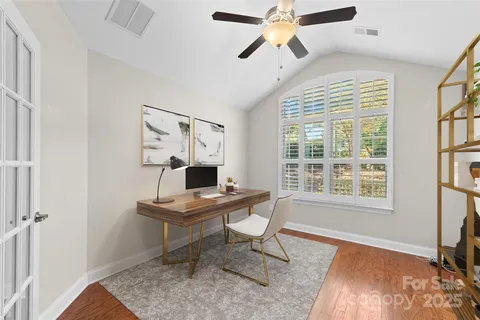 a workspace with wooden floor and a window