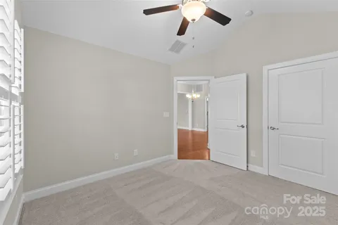 an empty room with a empty space and a ceiling fan