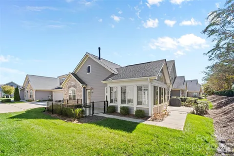 a front view of a house with a yard table and chairs