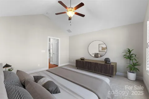 a bedroom with bed and a chandelier