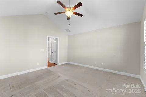 a view of a room with a ceiling fan and a window