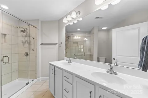 a bathroom with a sink double vanity and shower