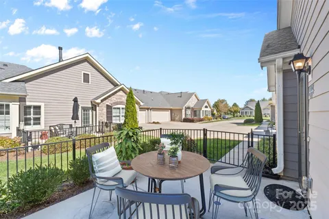 a view of a house with a yard and furniture