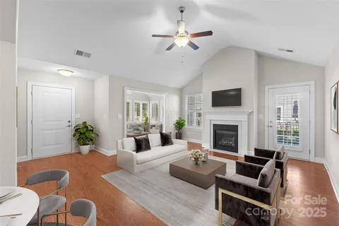 a living room with furniture or chandelier and a fireplace