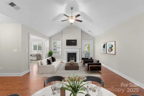 a living room with fireplace furniture and a wooden floor