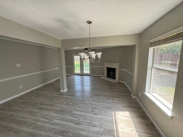 a view of a hallway with wooden floor and a fireplace