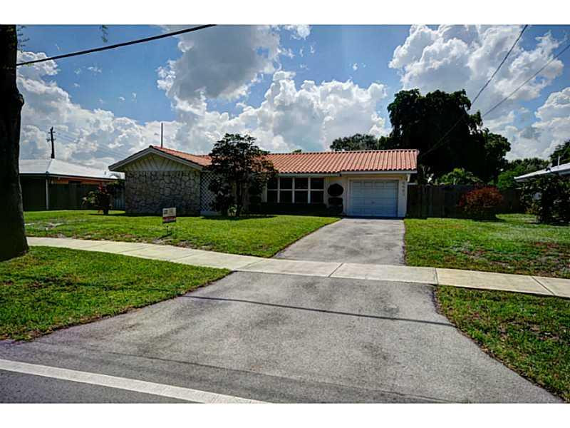 4441 Northeast 22nd Avenue Lighthouse Point, FL 33064 - Photo 1 of 18 a front view of house with yard