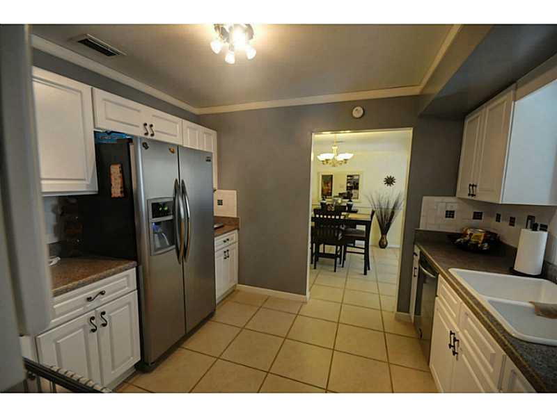 4441 Northeast 22nd Avenue Lighthouse Point, FL 33064 - Photo 2 of 18 a kitchen with stainless steel appliances a refrigerator sink and cabinets