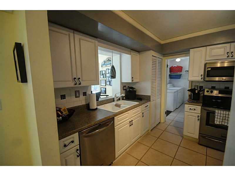 4441 Northeast 22nd Avenue Lighthouse Point, FL 33064 - Photo 3 of 18 a kitchen with stainless steel appliances a sink stove and refrigerator