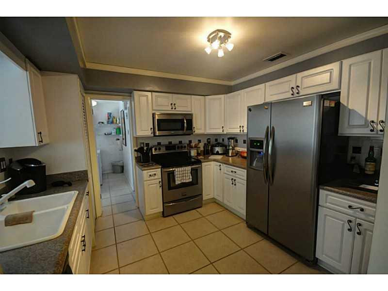 4441 Northeast 22nd Avenue Lighthouse Point, FL 33064 - Photo 4 of 18 a kitchen with a sink stainless steel appliances and cabinets
