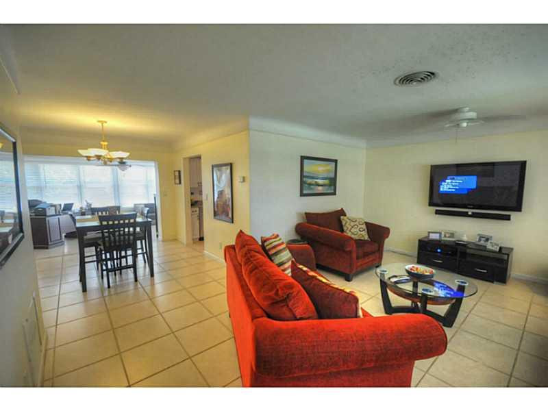4441 Northeast 22nd Avenue Lighthouse Point, FL 33064 - Photo 5 of 18 a living room with furniture and a flat screen tv