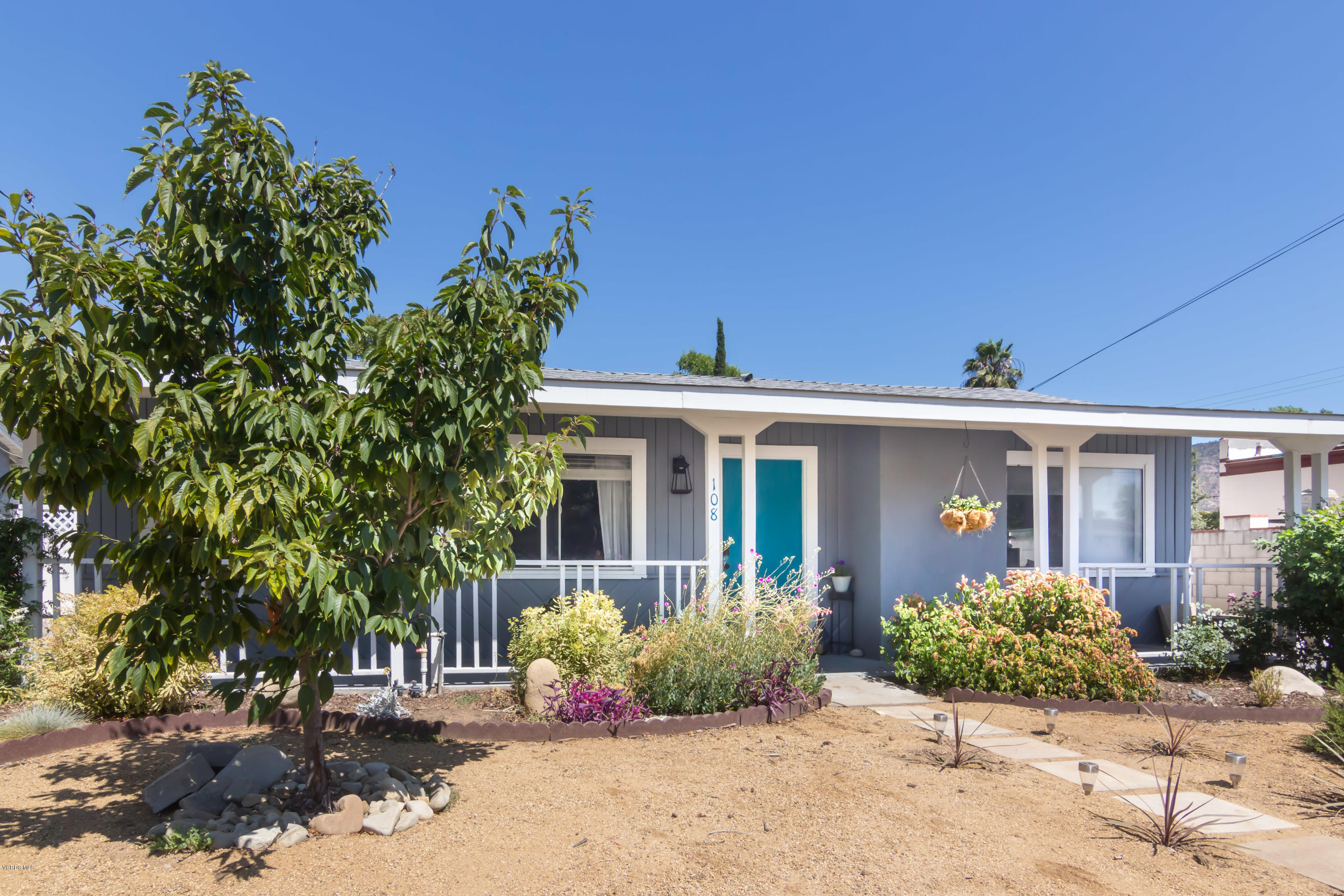 front view of a house with a bench