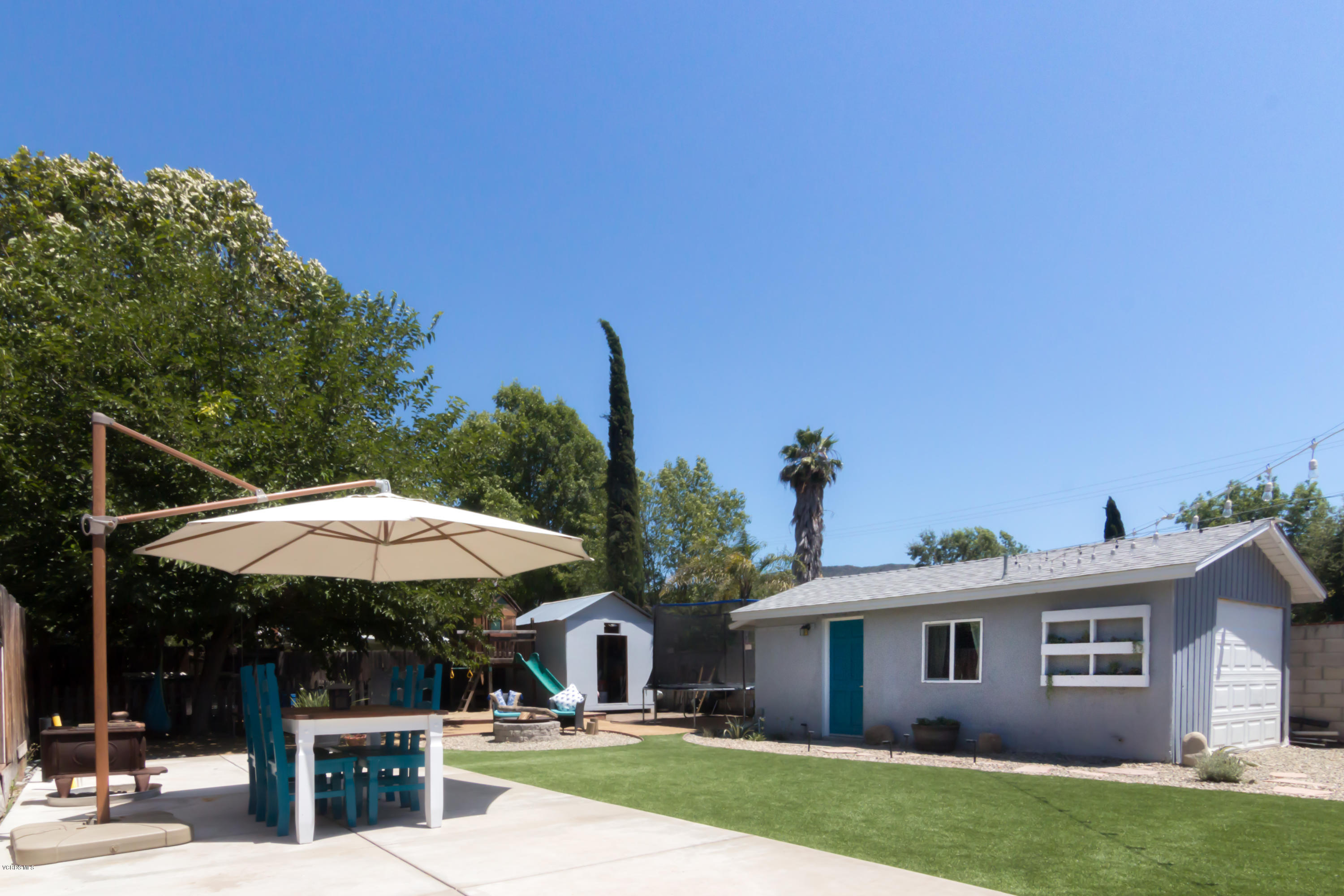 108 Drown Avenue Ojai, CA 93023 - Photo 17 of 37 a patio with a table and chairs under an umbrella