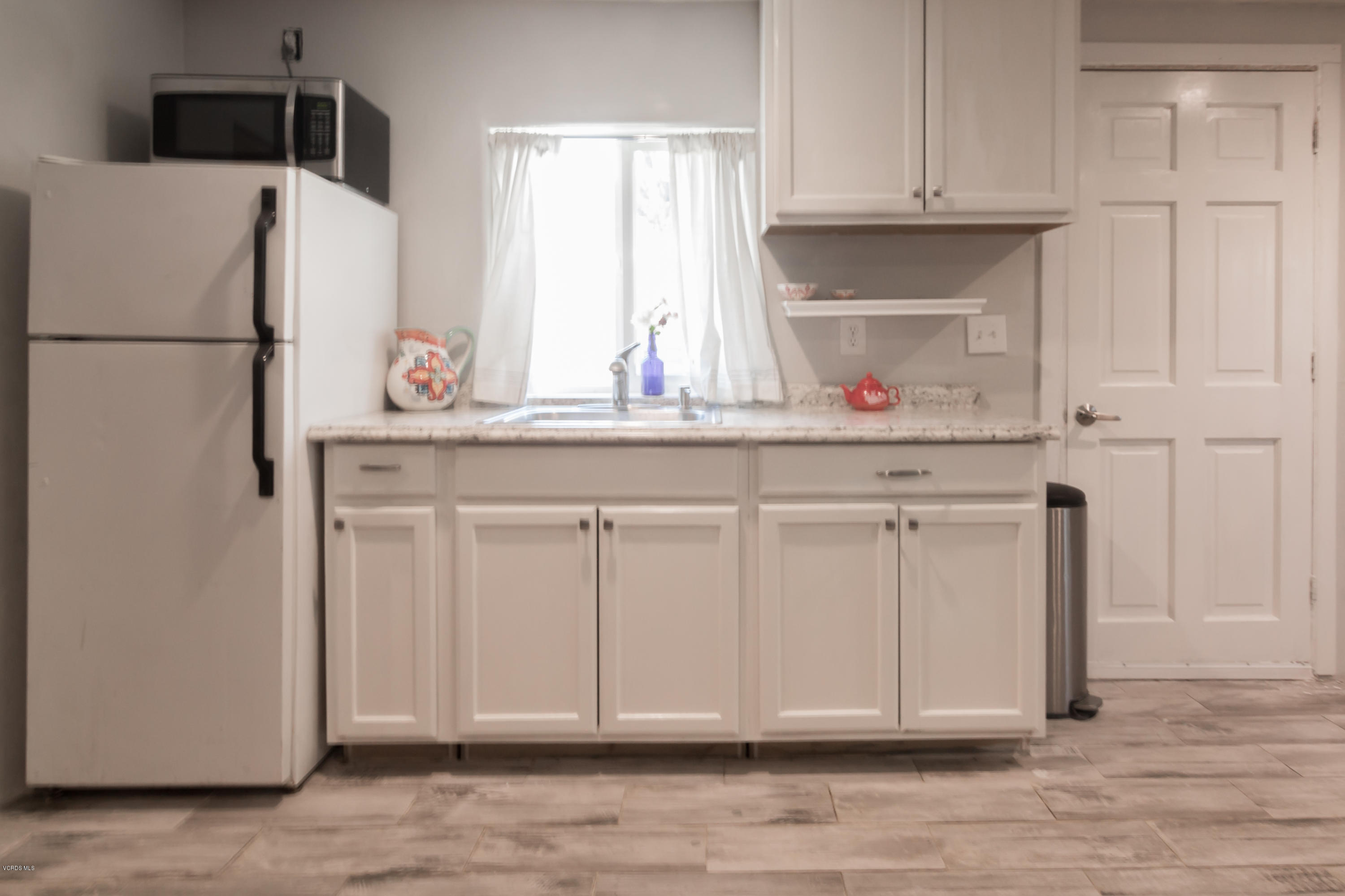 108 Drown Avenue Ojai, CA 93023 - Photo 24 of 37 a kitchen with cabinets and a refrigerator