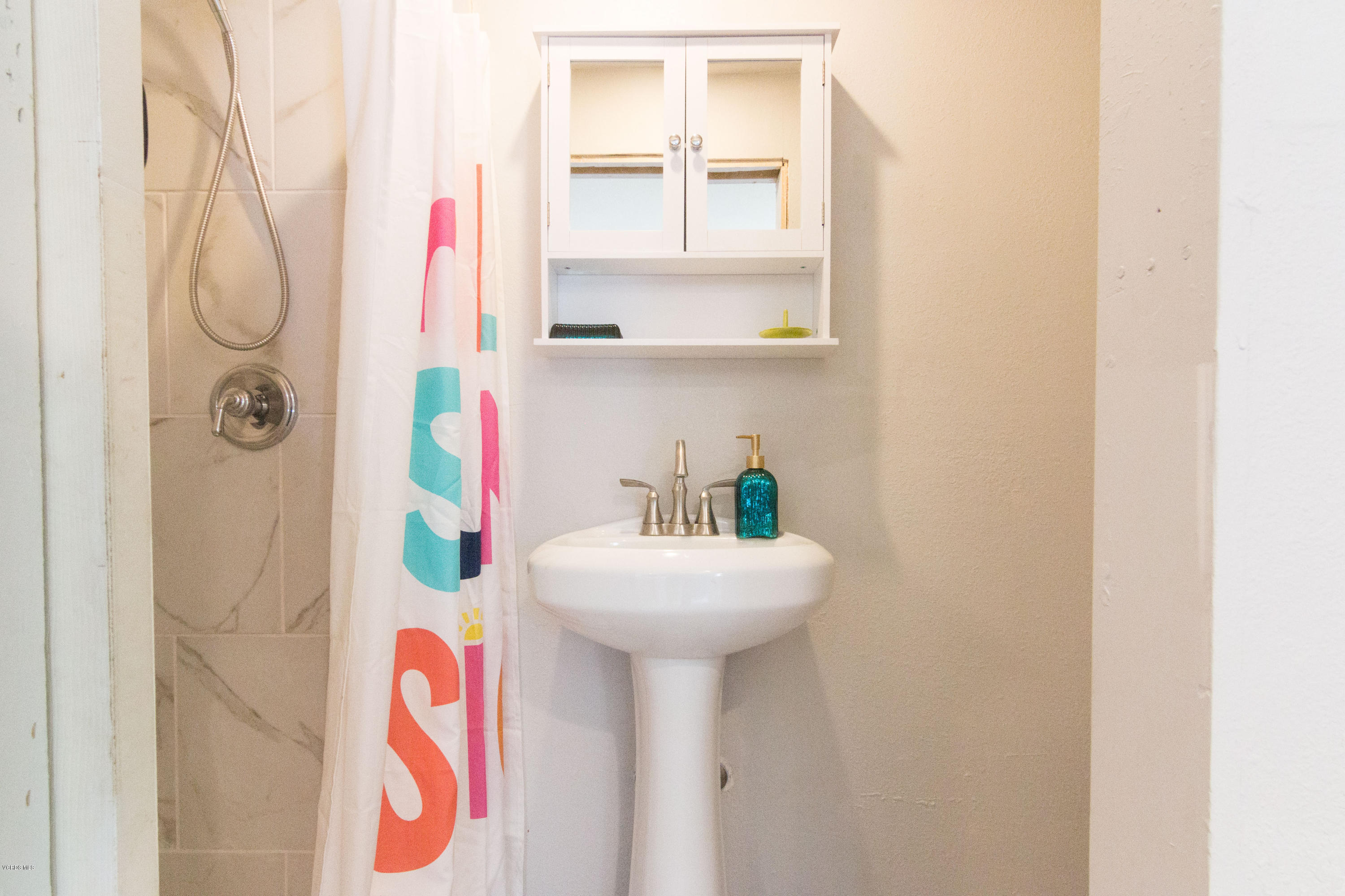 108 Drown Avenue Ojai, CA 93023 - Photo 25 of 37 a bathroom with a sink and mirror with bathtub