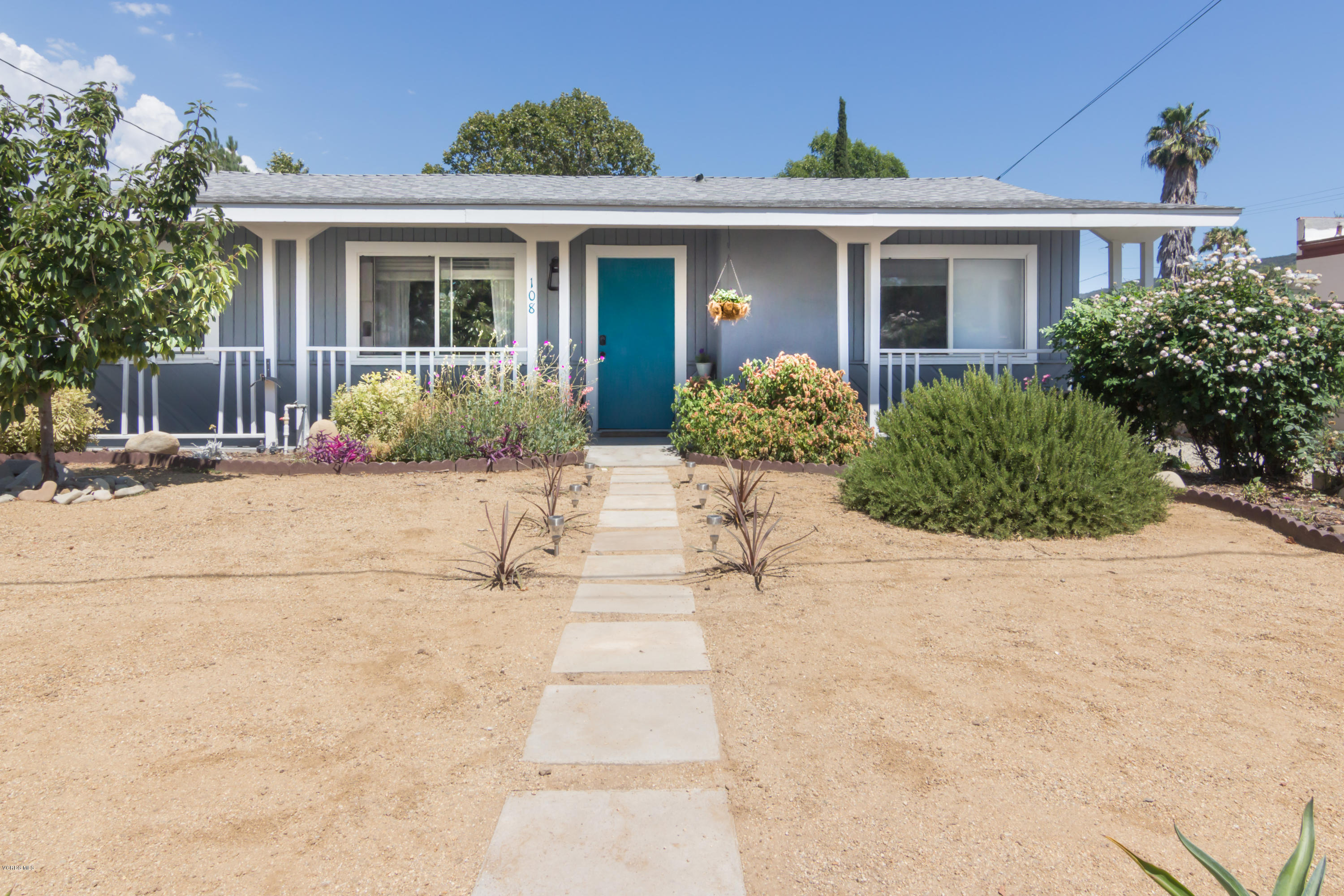 108 Drown Avenue Ojai, CA 93023 - Photo 36 of 37 a front view of a house with a yard and potted plants