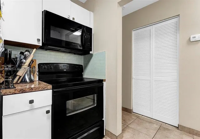 a kitchen with a stove and a microwave