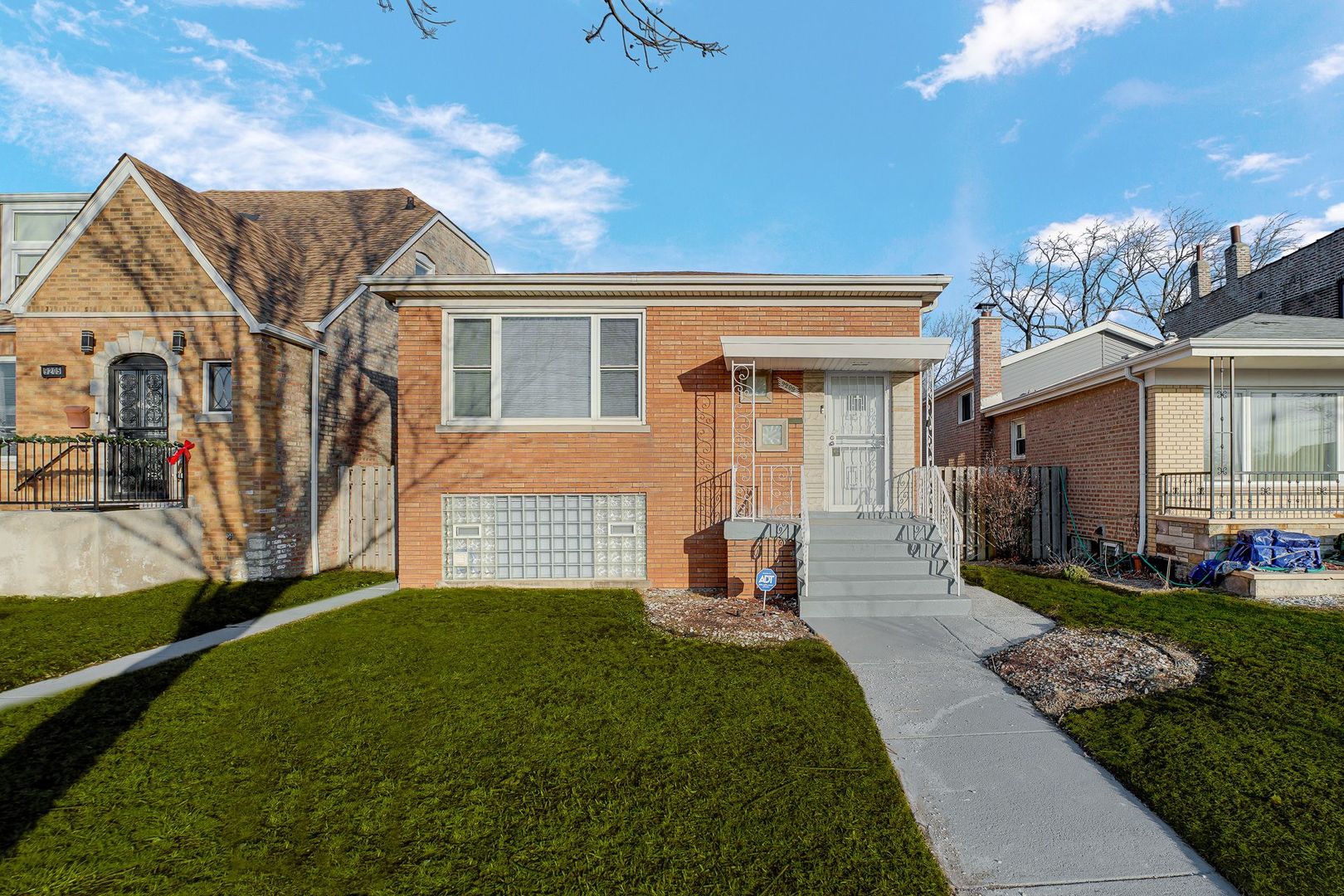 9209 South State Street Chicago, IL 60619 - Photo 1 of 20 a front view of a house with a garden and plants