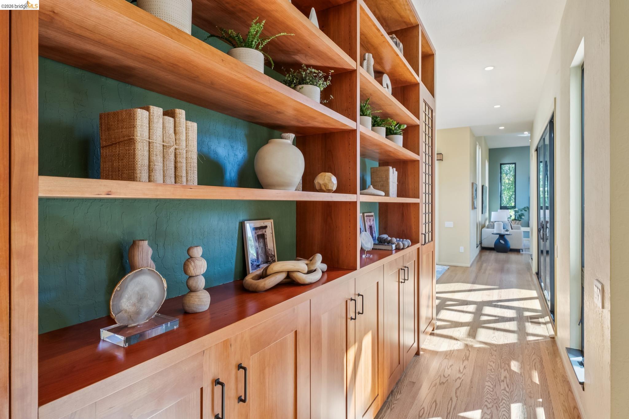 576 Vistamont Avenue Berkeley, CA 94708 - Photo 7 of 33 Custom built-in shelving with wood-finish construction and a deep green back panel